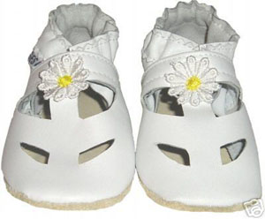 A classy solid white sandal with white trim and yellow centered daisy. Top cut-outs help to keep little feet cool.