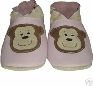 Funky monkey face in a light pink leather crib shoe.